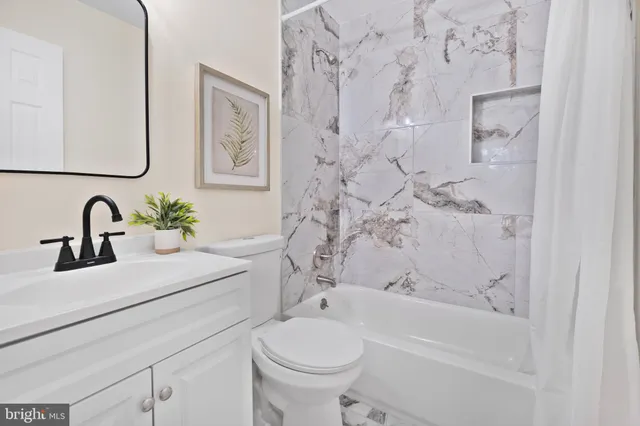 a bathroom with a sink a toilet and a bathtub