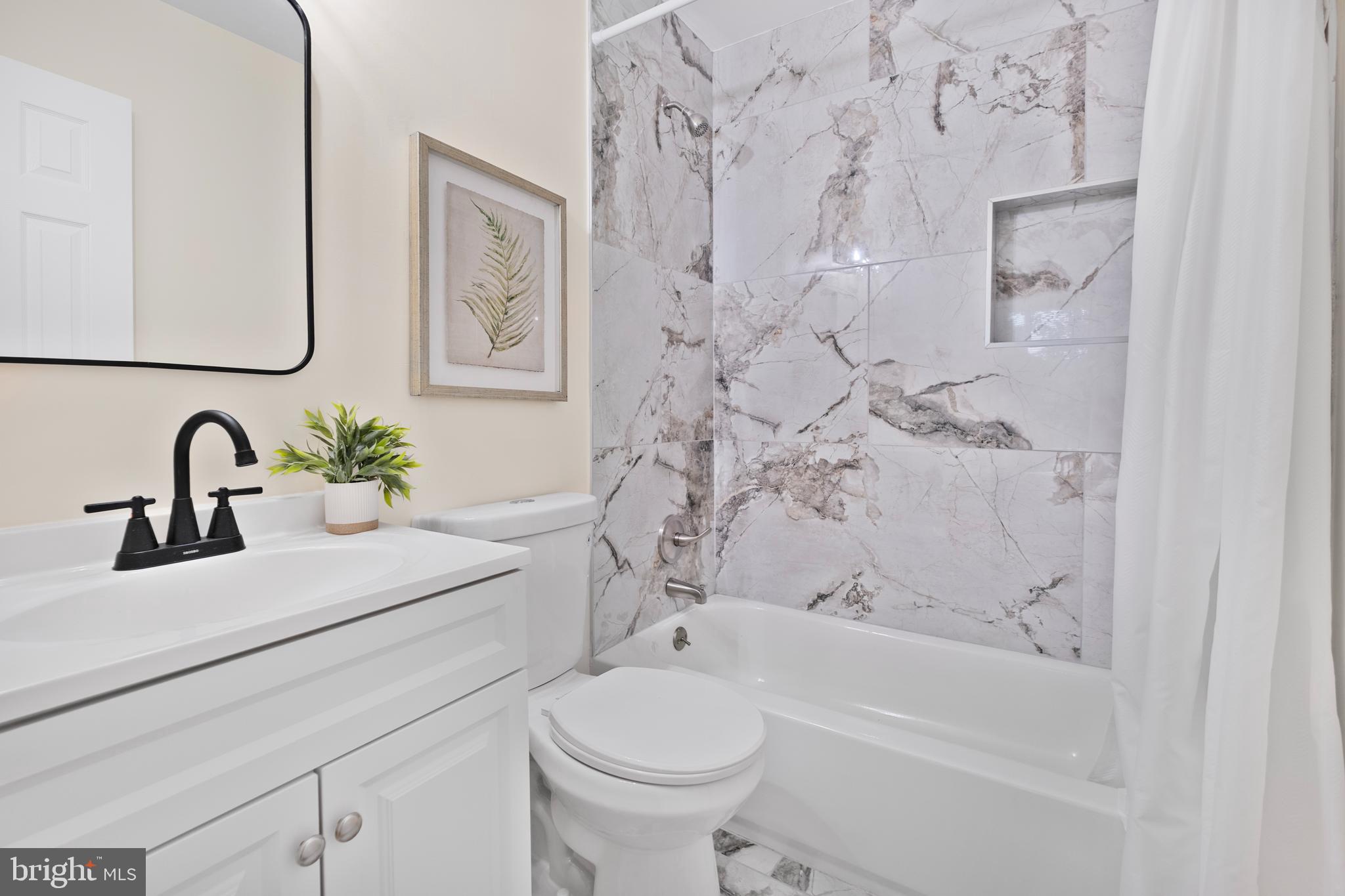 713 Marcy Avenue Oxon Hill, MD 20745 - Photo 13 of 24 a bathroom with a sink a toilet and a bathtub