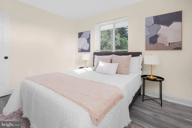 a bedroom with a bed and a painting on the wall