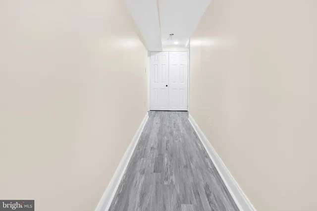 a view of a room with wooden floor