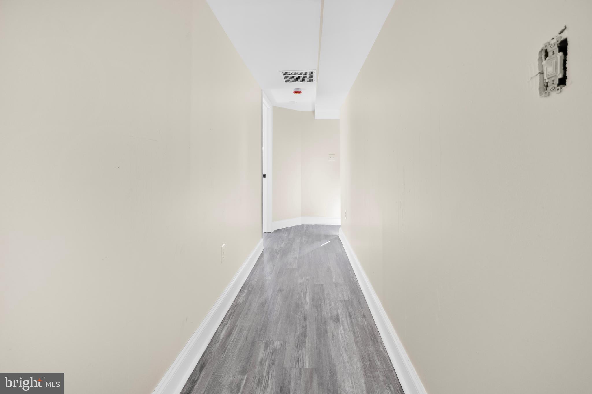 713 Marcy Avenue Oxon Hill, MD 20745 - Photo 23 of 24 a view of a hallway with wooden floor