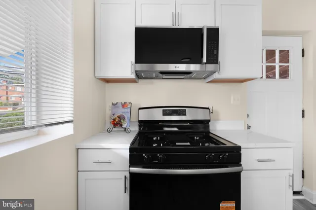 a kitchen with a stove and a microwave