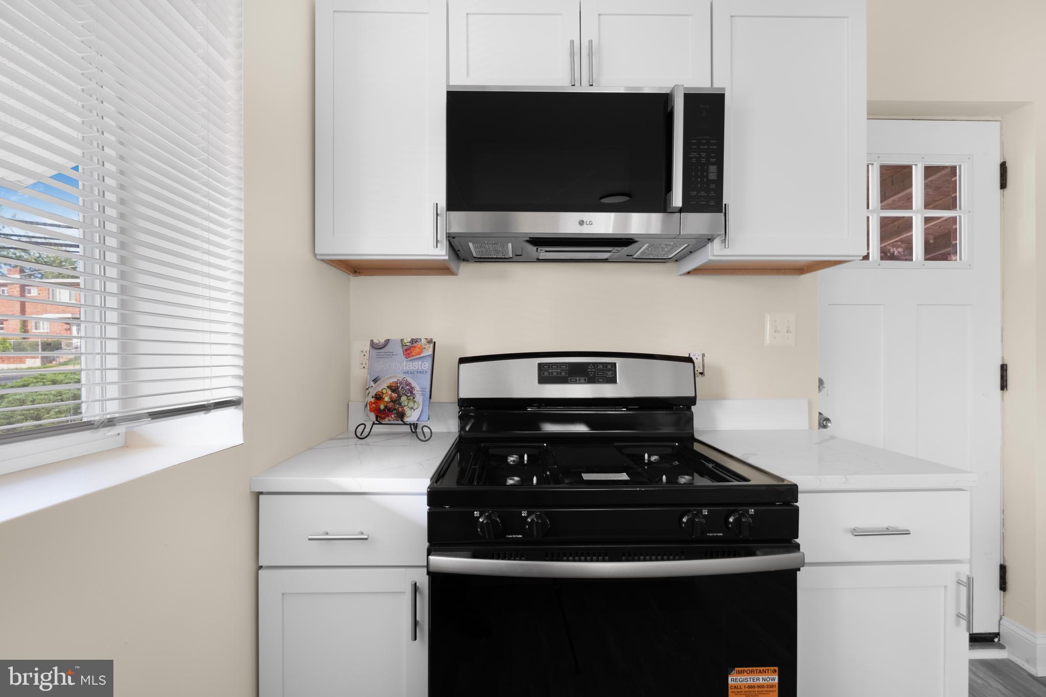 713 Marcy Avenue Oxon Hill, MD 20745 - Photo 7 of 24 a kitchen with a stove and a microwave