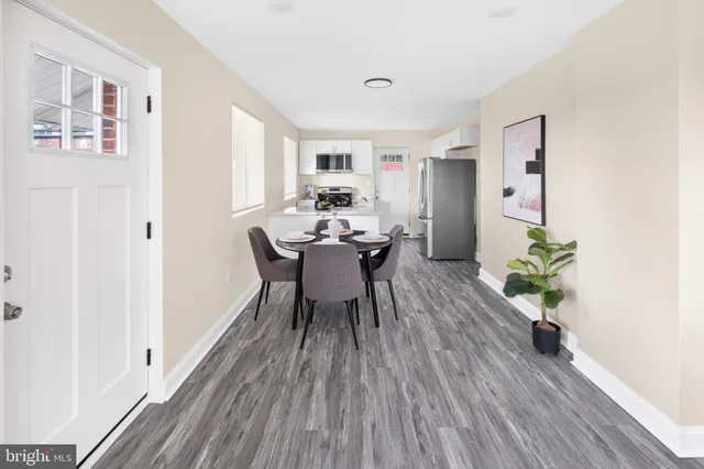 a dining room with furniture and wooden floor