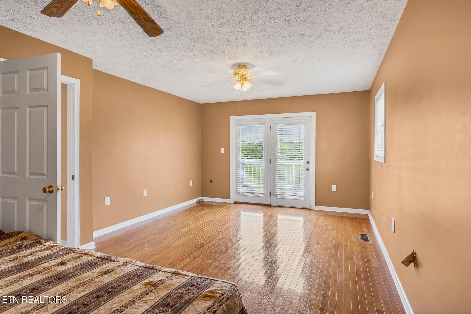 1565 Ellejoy Road Seymour, TN 37865 - Photo 14 of 27 a view of a bedroom with wooden floor and window
