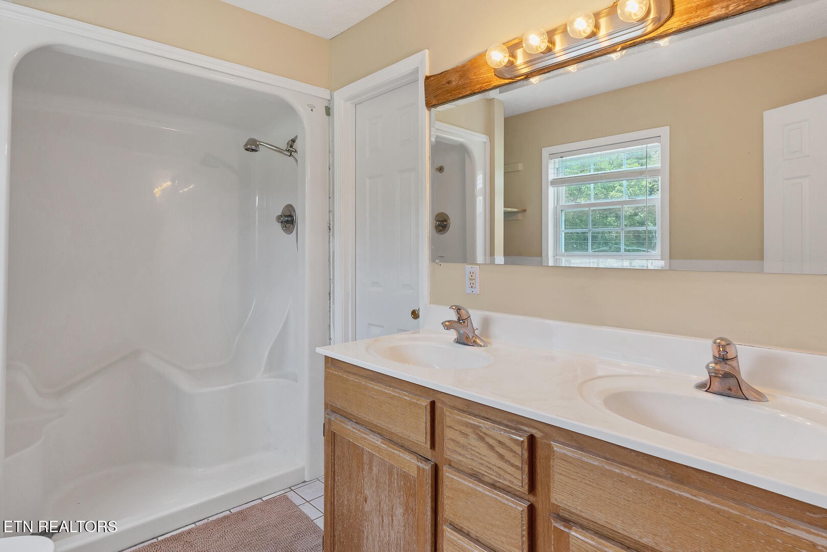 1565 Ellejoy Road Seymour, TN 37865 - Photo 15 of 27 a bathroom with a sink a shower and a mirror