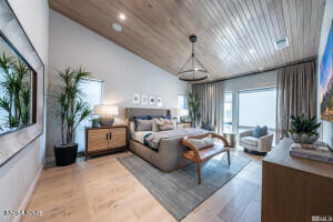 82 Caballada Street Reno, NV 89511 - Photo 13 of 39 a large bedroom with a large bed and a chandelier