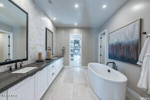 82 Caballada Street Reno, NV 89511 - Photo 14 of 39 a bathroom with a granite countertop sink mirror and bathtub