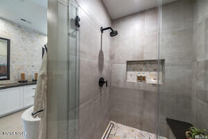 82 Caballada Street Reno, NV 89511 - Photo 15 of 39 a bathroom with a granite countertop shower mirror and toilet