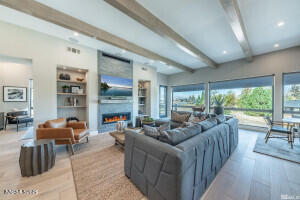 82 Caballada Street Reno, NV 89511 - Photo 7 of 39 a living room with furniture a rug potted plant and a large window