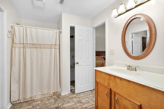 a bathroom with a sink a mirror and a shower