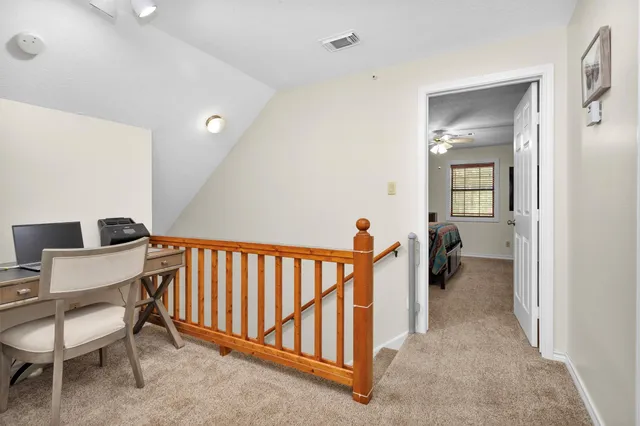 a view of a hallway with a livingroom and a furniture
