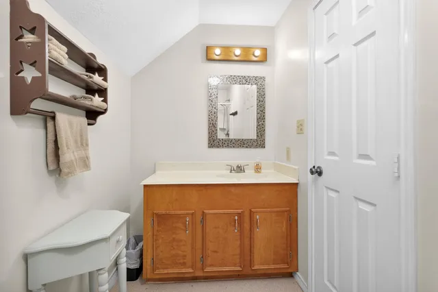 a bathroom with a sink a mirror and a toilet