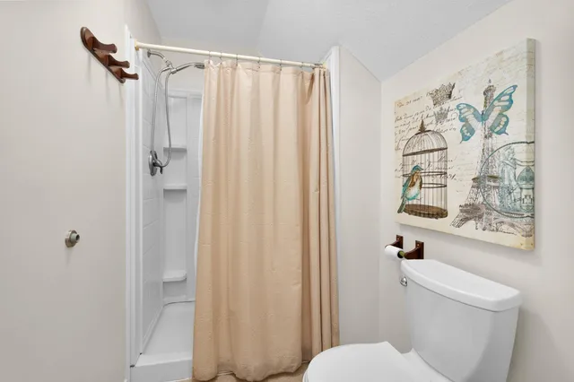 a white toilet sitting next to a bathroom sink