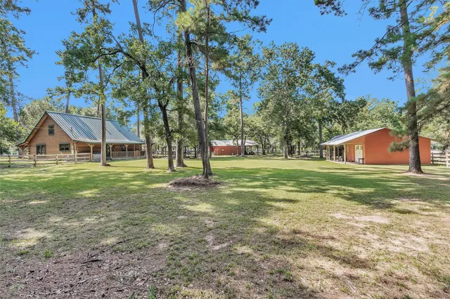 a view of a house with yard and tree s