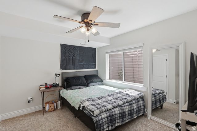 10676 Urban Rdg Cove South Jordan, UT 84095 - Photo 21 of 48 Carpeted room featuring a ceiling fan with integrated lighting, a window with blinds, and white baseboards