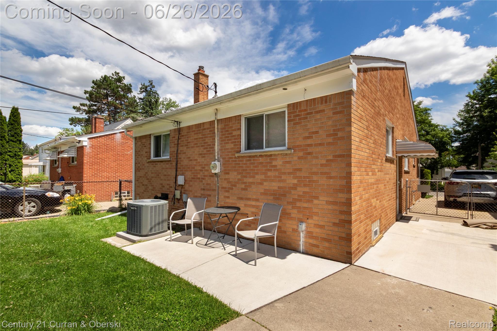 3220 Alice Street Dearborn, MI 48124 - Photo 38 of 39 Brick exterior featuring a concrete patio, grassy yard, and a paved driveway