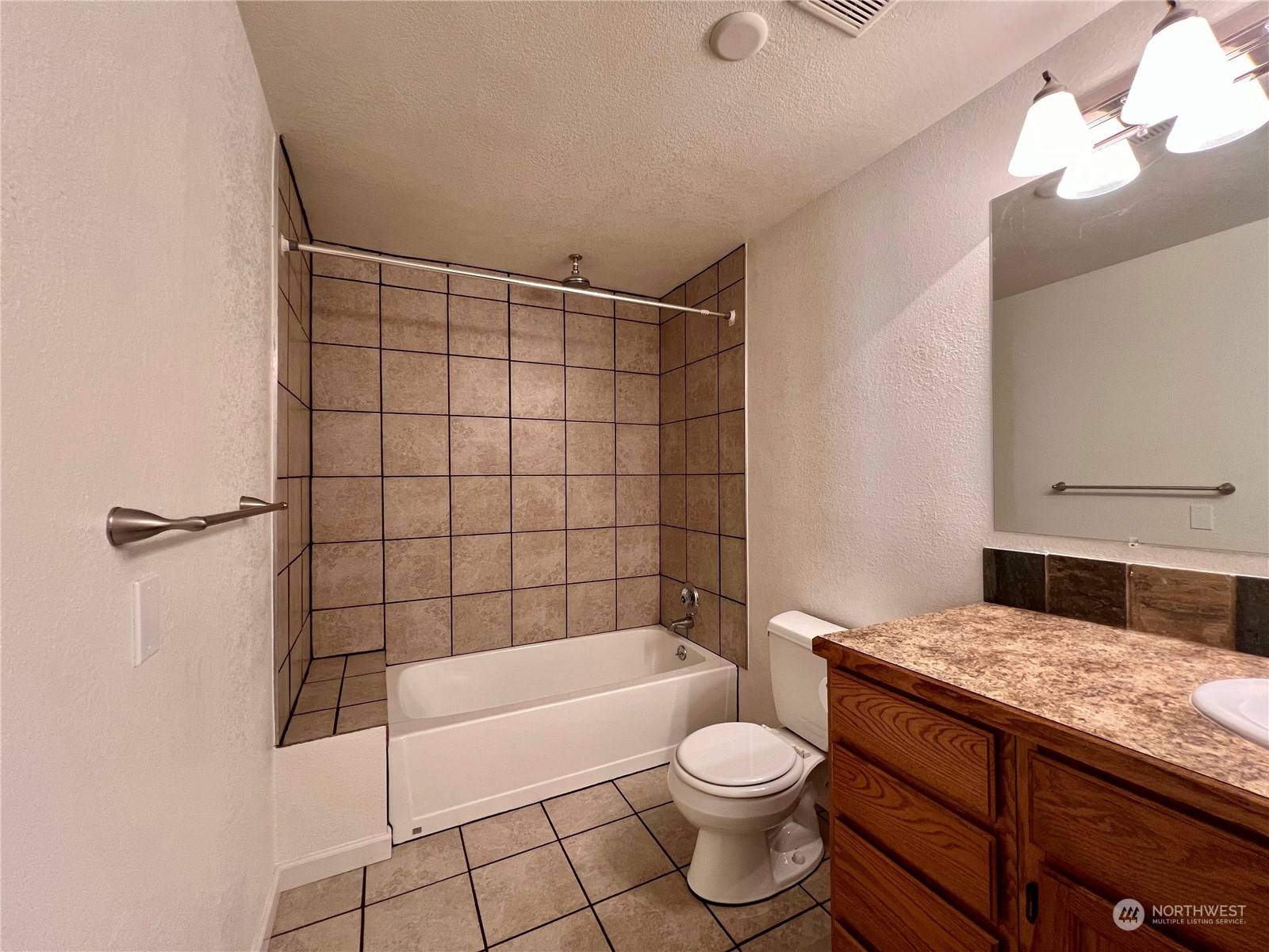 1951 Southeast Van Skiver Road Port Orchard, WA 98367 - Photo 13 of 30 a bathroom with a granite countertop bathtub shower sink vanity and toilet