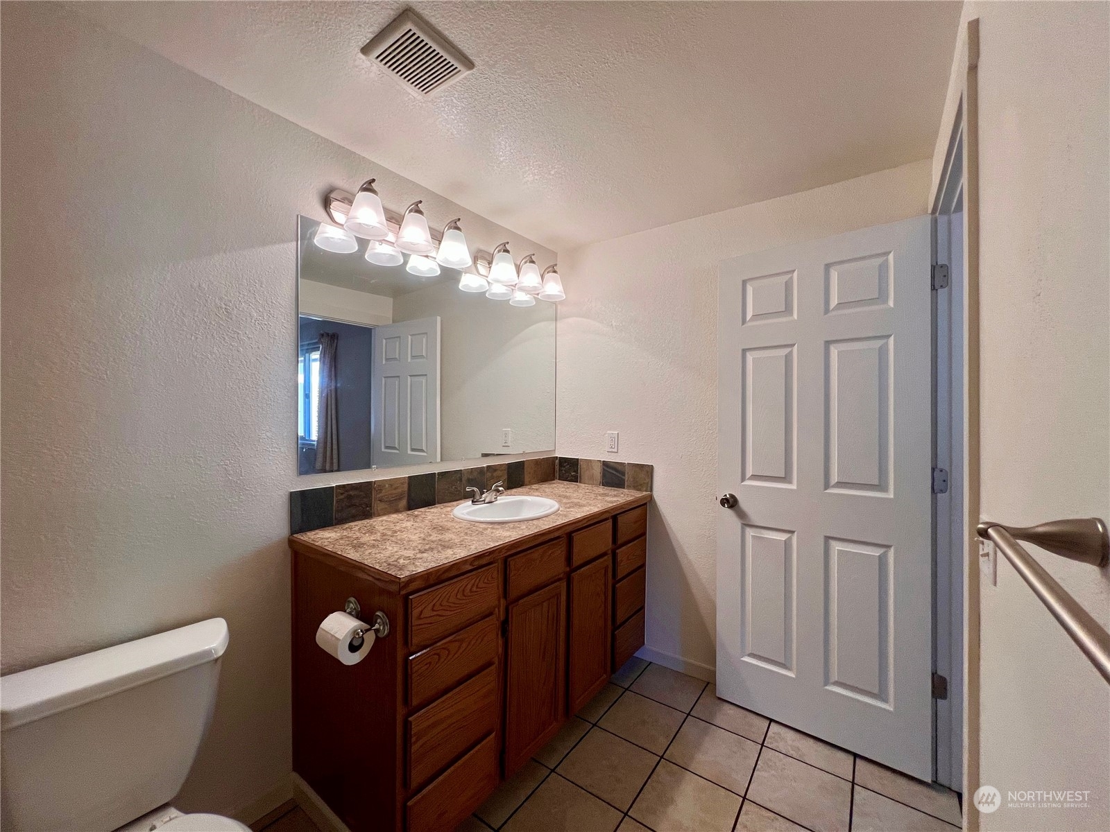 1951 Southeast Van Skiver Road Port Orchard, WA 98367 - Photo 14 of 30 a bathroom with a toilet sink and mirror