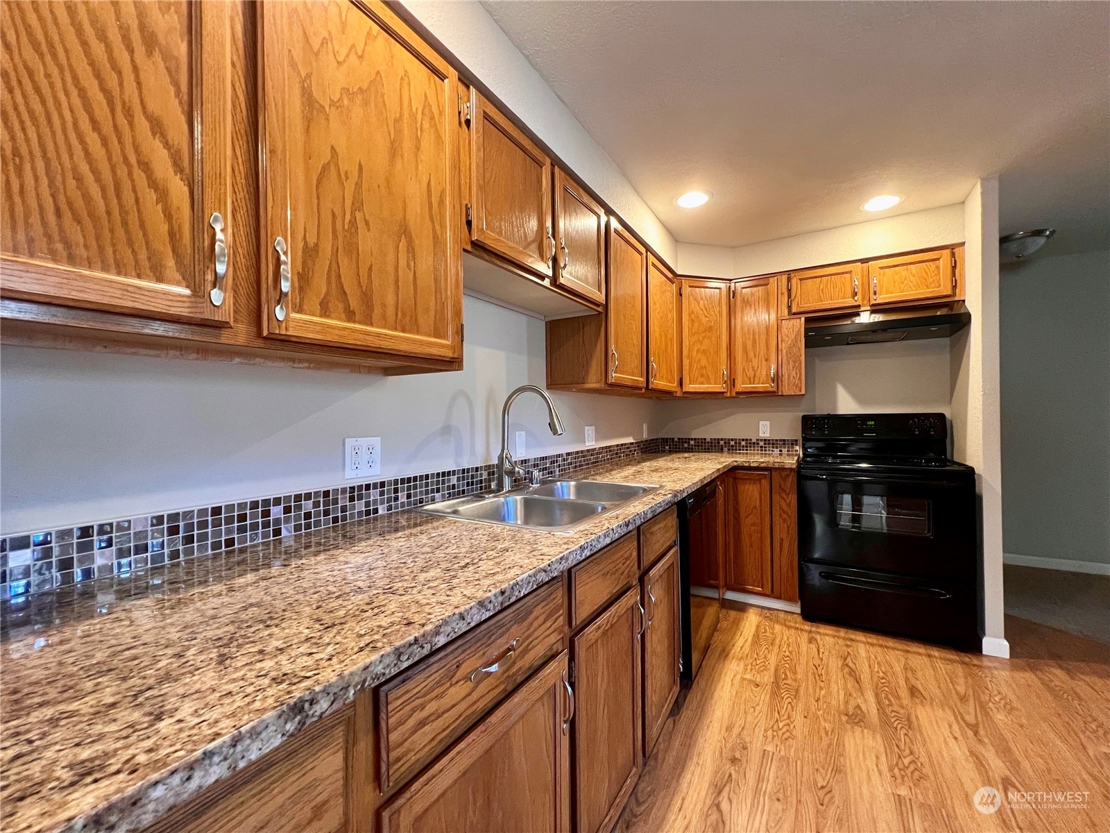 1951 Southeast Van Skiver Road Port Orchard, WA 98367 - Photo 10 of 30 a kitchen with granite countertop a sink and cabinets