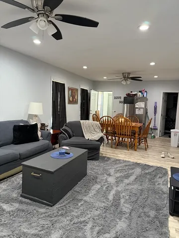 a living room with furniture and kitchen view
