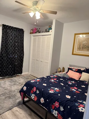 a bedroom with a bed window and a chandelier