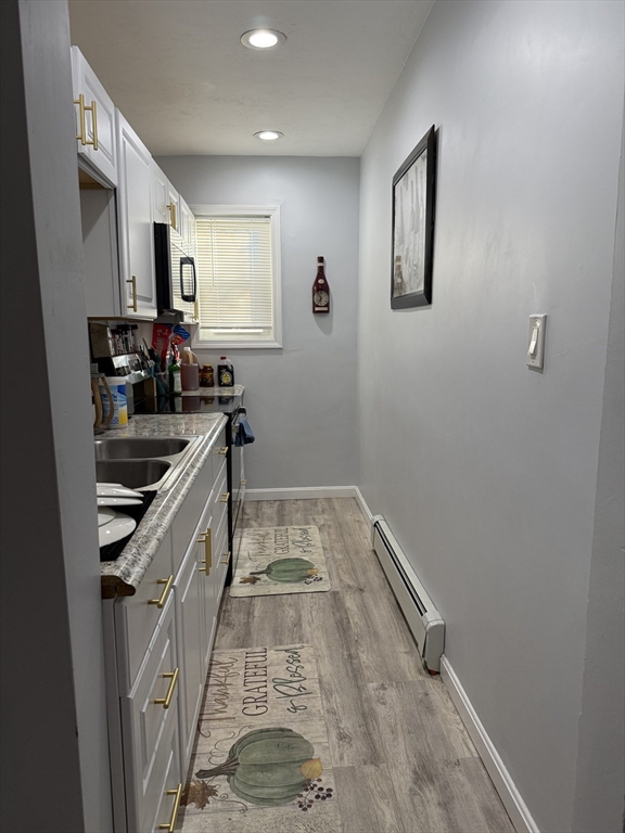 145 Eastern Avenue Worcester, MA 01605 - Photo 6 of 10 a kitchen with sink and cabinets