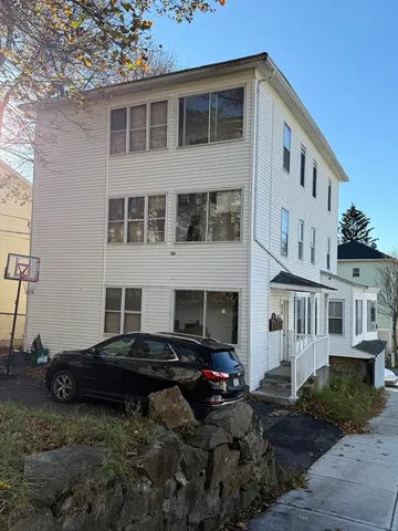 a view of a house with backyard and sitting area