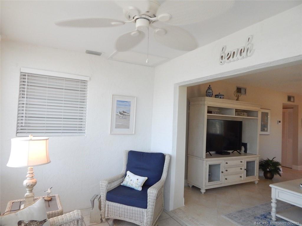 2950 Southeast Ocean Boulevard, Unit 74 Stuart, FL 34996 - Photo 12 of 39 a living room with furniture and a flat screen tv