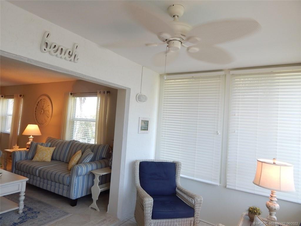 2950 Southeast Ocean Boulevard, Unit 74 Stuart, FL 34996 - Photo 13 of 39 a living room with furniture and a lamp