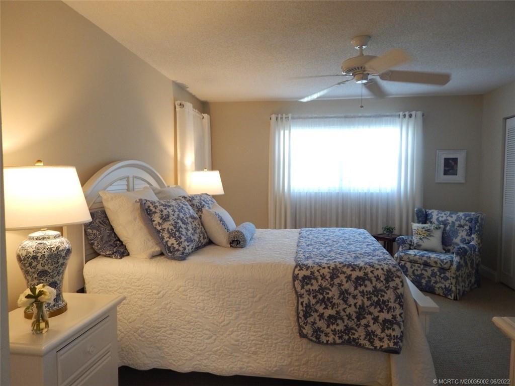2950 Southeast Ocean Boulevard, Unit 74 Stuart, FL 34996 - Photo 14 of 39 a bedroom with a bed and window