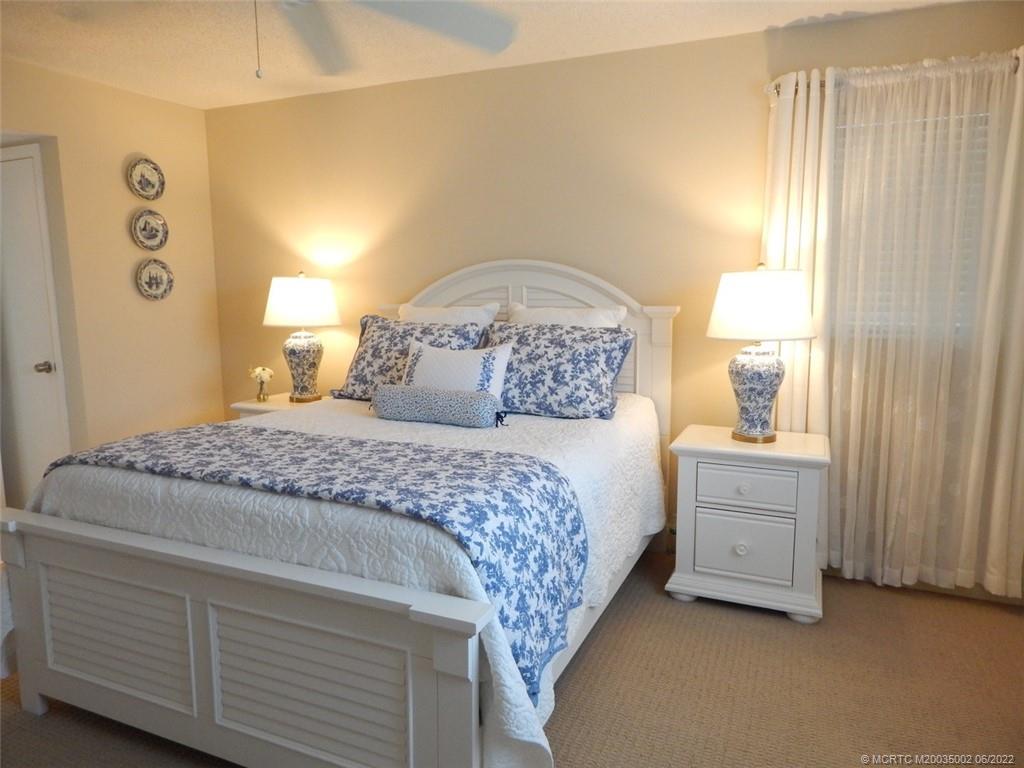 2950 Southeast Ocean Boulevard, Unit 74 Stuart, FL 34996 - Photo 18 of 39 a bedroom with a bed and a window