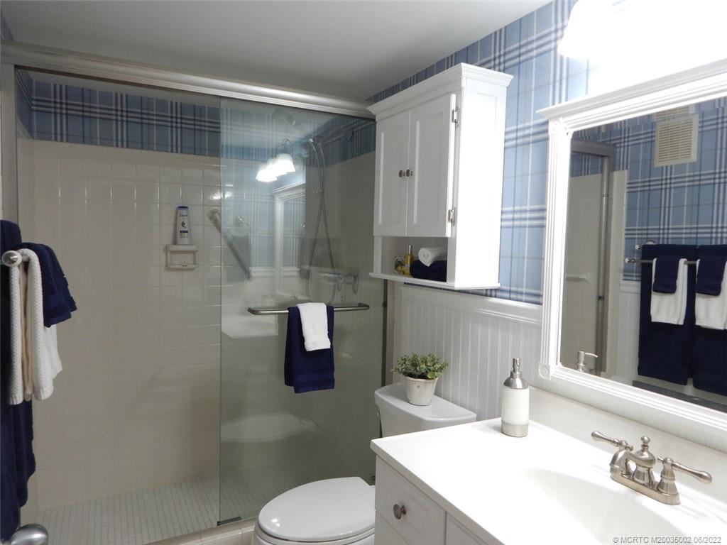 2950 Southeast Ocean Boulevard, Unit 74 Stuart, FL 34996 - Photo 19 of 39 a bathroom with a sink a toilet and shower