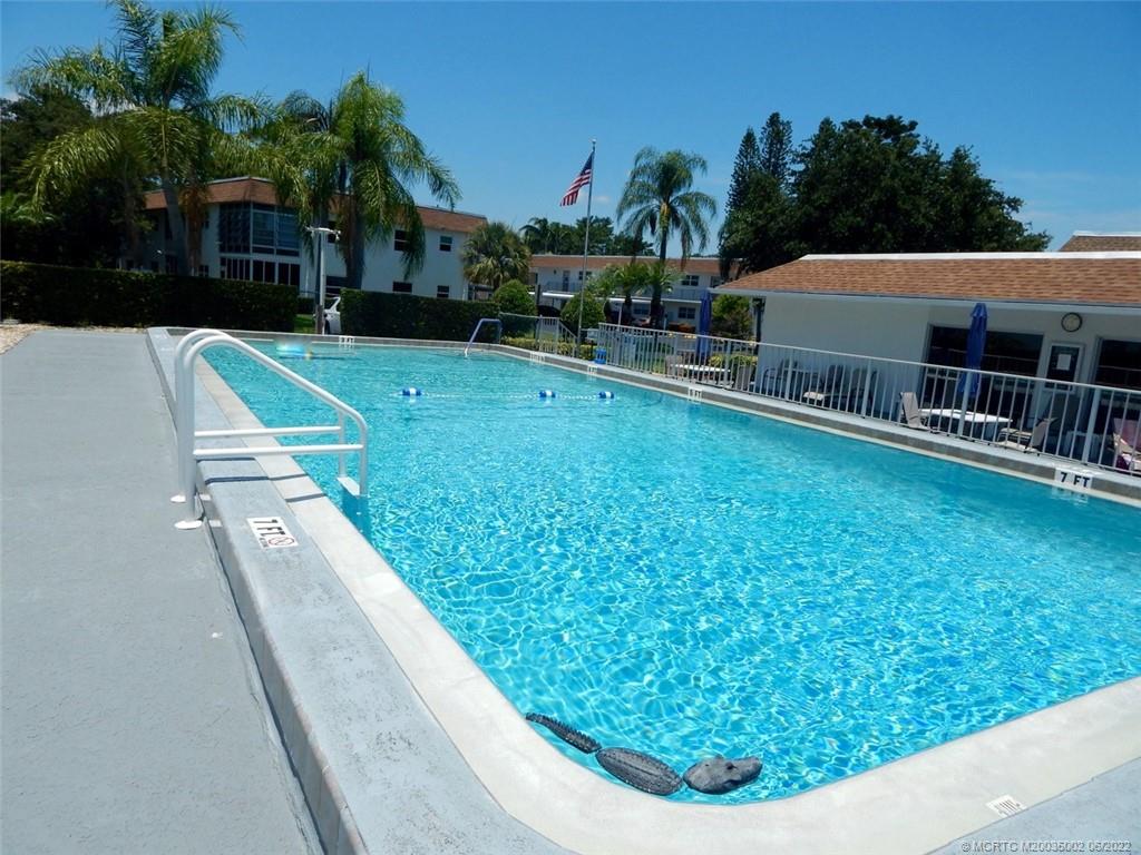 2950 Southeast Ocean Boulevard, Unit 74 Stuart, FL 34996 - Photo 2 of 39 a view of a house with a yard patio and swimming pool
