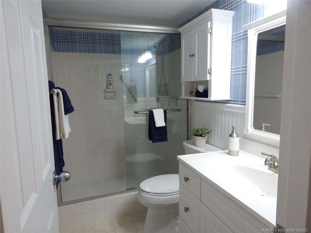 2950 Southeast Ocean Boulevard, Unit 74 Stuart, FL 34996 - Photo 21 of 39 a bathroom with a sink toilet and shower