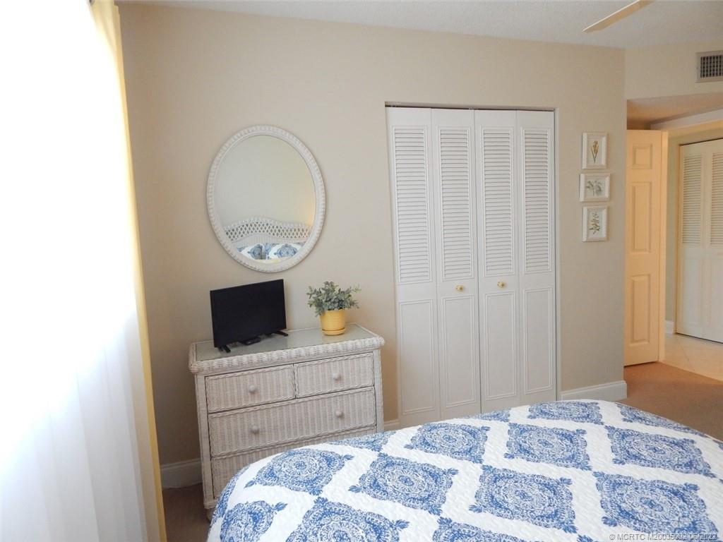 2950 Southeast Ocean Boulevard, Unit 74 Stuart, FL 34996 - Photo 23 of 39 a bedroom with a bed and a table in it