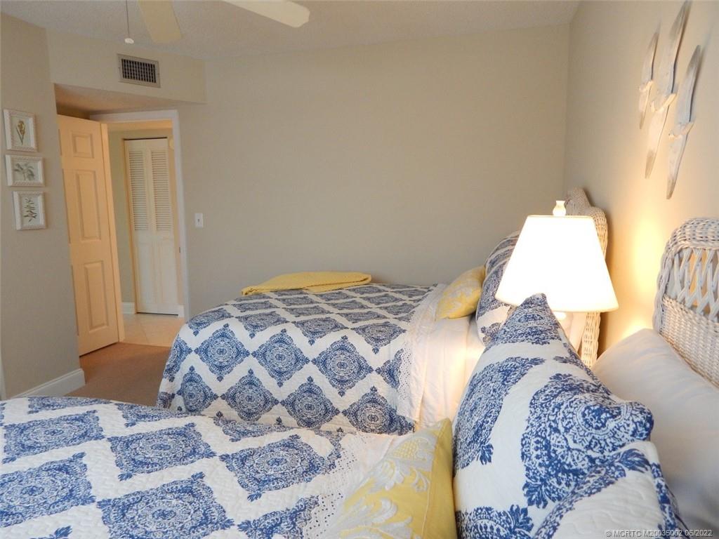 2950 Southeast Ocean Boulevard, Unit 74 Stuart, FL 34996 - Photo 24 of 39 a bedroom with a bed and a window