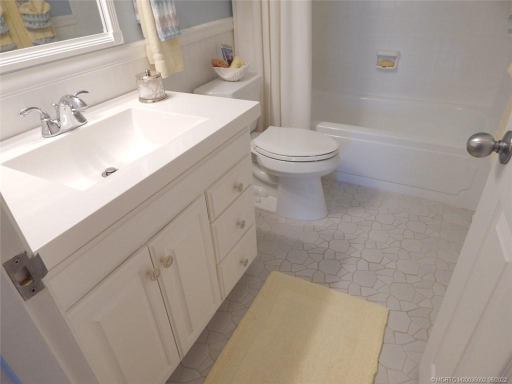 2950 Southeast Ocean Boulevard, Unit 74 Stuart, FL 34996 - Photo 28 of 39 a bathroom with a sink a toilet and shower