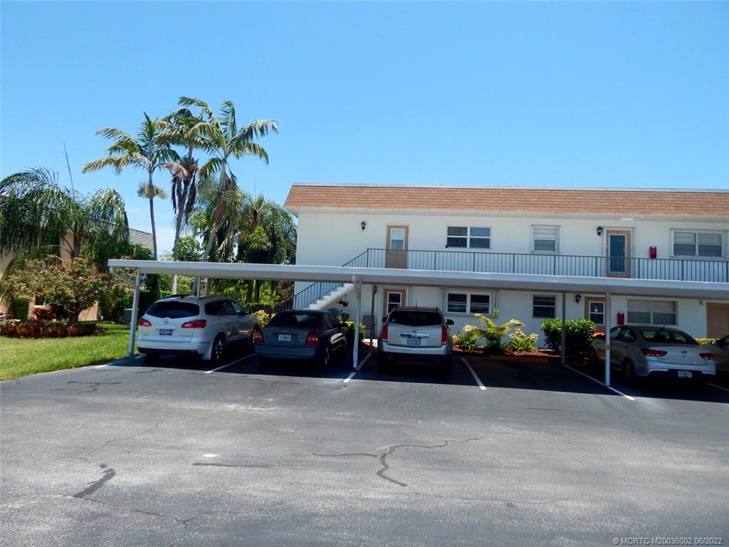 2950 Southeast Ocean Boulevard, Unit 74 Stuart, FL 34996 - Photo 31 of 39 a car parked in front of a building and cars park