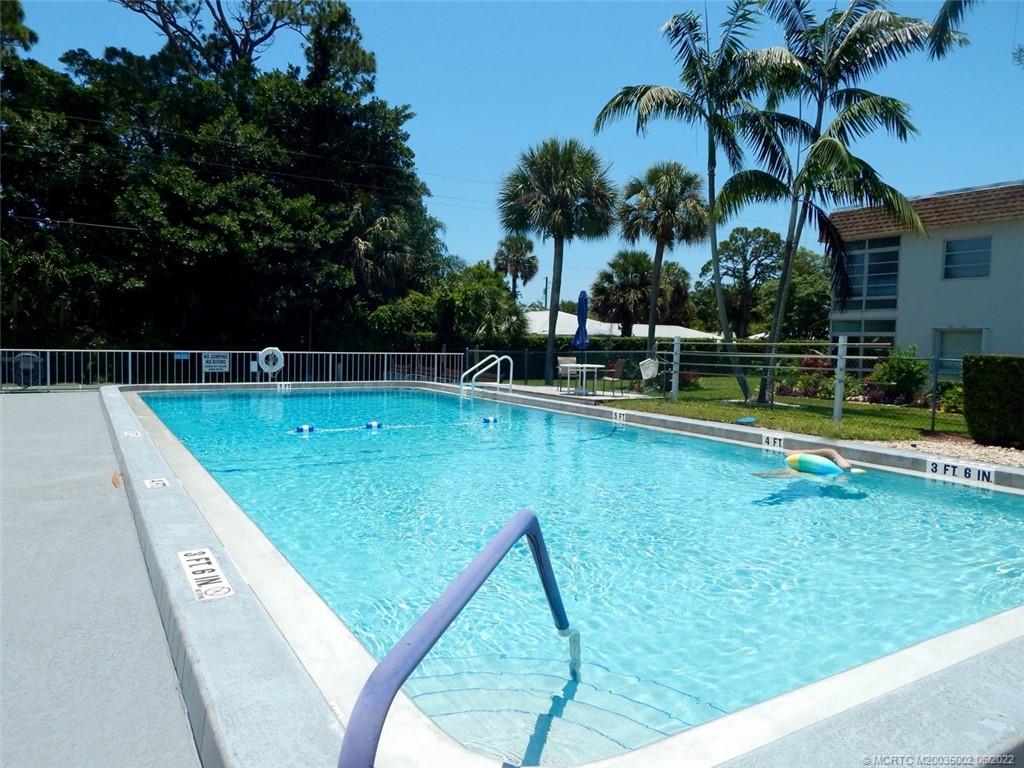 2950 Southeast Ocean Boulevard, Unit 74 Stuart, FL 34996 - Photo 37 of 39 a view of a backyard with swimming pool