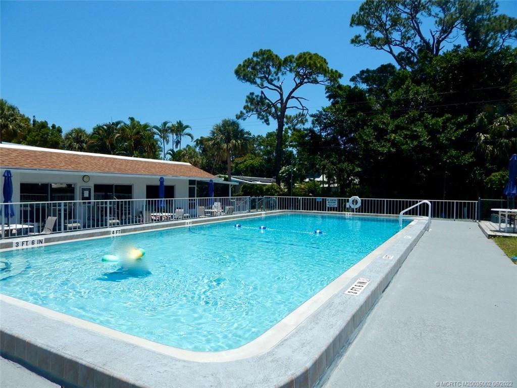 2950 Southeast Ocean Boulevard, Unit 74 Stuart, FL 34996 - Photo 38 of 39 a view of a swimming pool with a garden