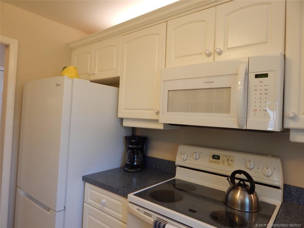 2950 Southeast Ocean Boulevard, Unit 74 Stuart, FL 34996 - Photo 6 of 39 a kitchen with a sink and cabinets