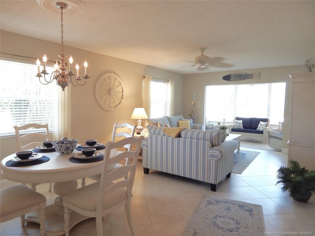2950 Southeast Ocean Boulevard, Unit 74 Stuart, FL 34996 - Photo 7 of 39 a living room with furniture chandelier and a chandelier