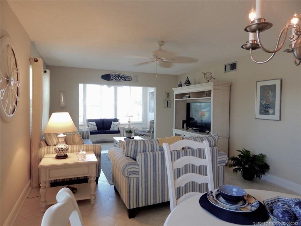 2950 Southeast Ocean Boulevard, Unit 74 Stuart, FL 34996 - Photo 8 of 39 a living room with furniture and a flat screen tv