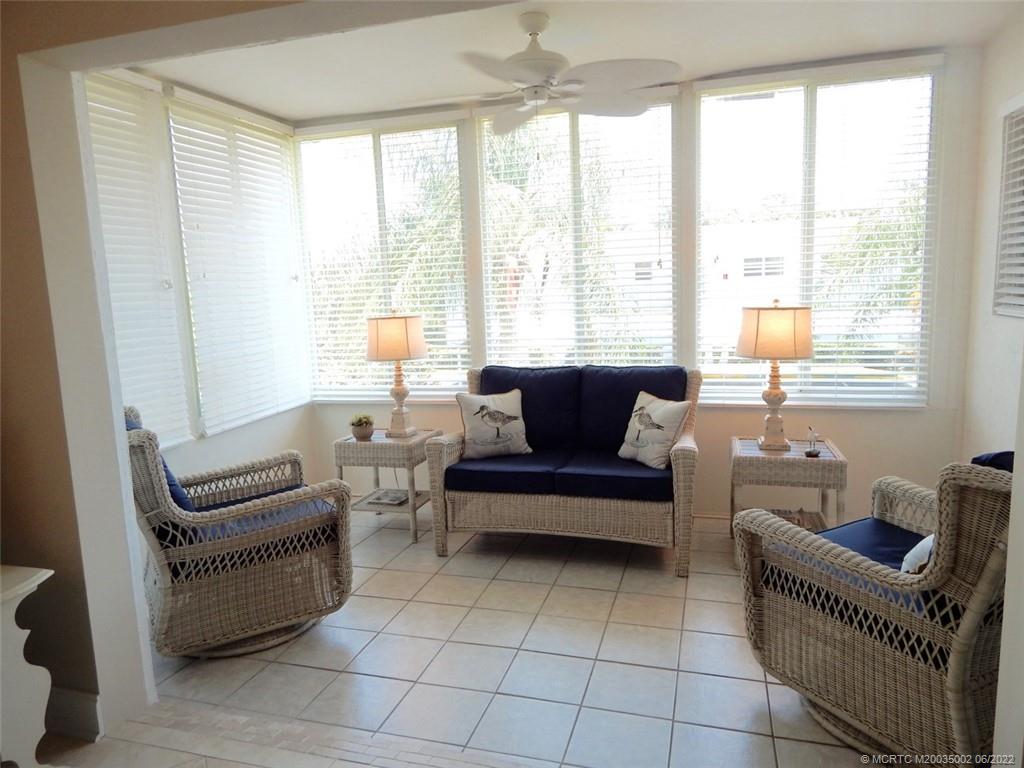 2950 Southeast Ocean Boulevard, Unit 74 Stuart, FL 34996 - Photo 9 of 39 a living room with furniture and a floor to ceiling window