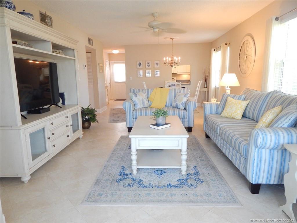 2950 Southeast Ocean Boulevard, Unit 74 Stuart, FL 34996 - Photo 10 of 39 a living room with furniture and a flat screen tv