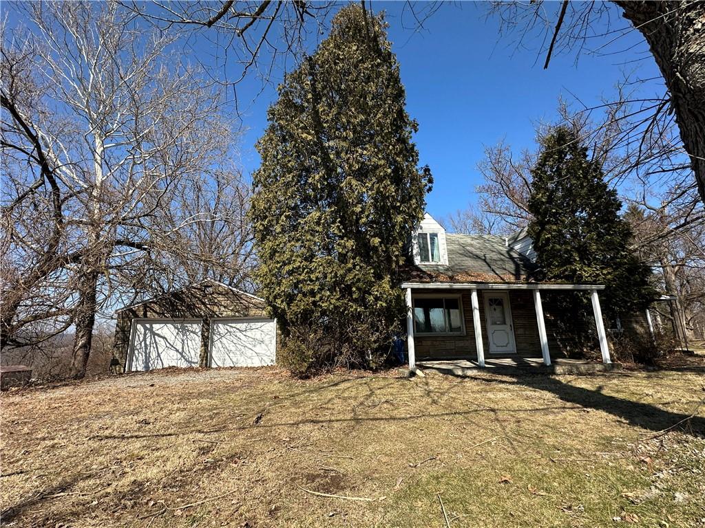 a view of a house with a yard covered with snow in front of house