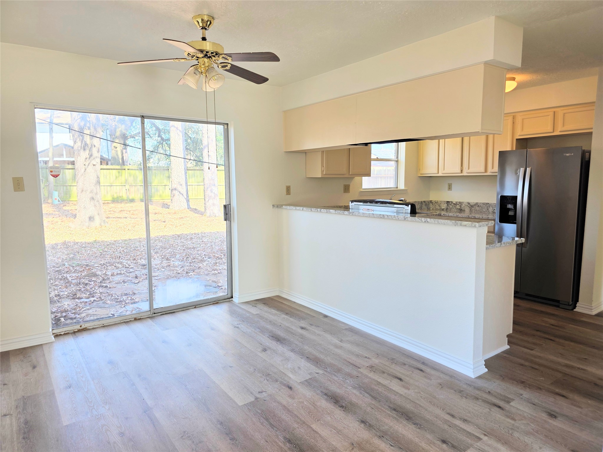 24022 Spring Briar Lane Spring, TX 77373 - Photo 7 of 35 a kitchen with wooden floors and a refrigerator
