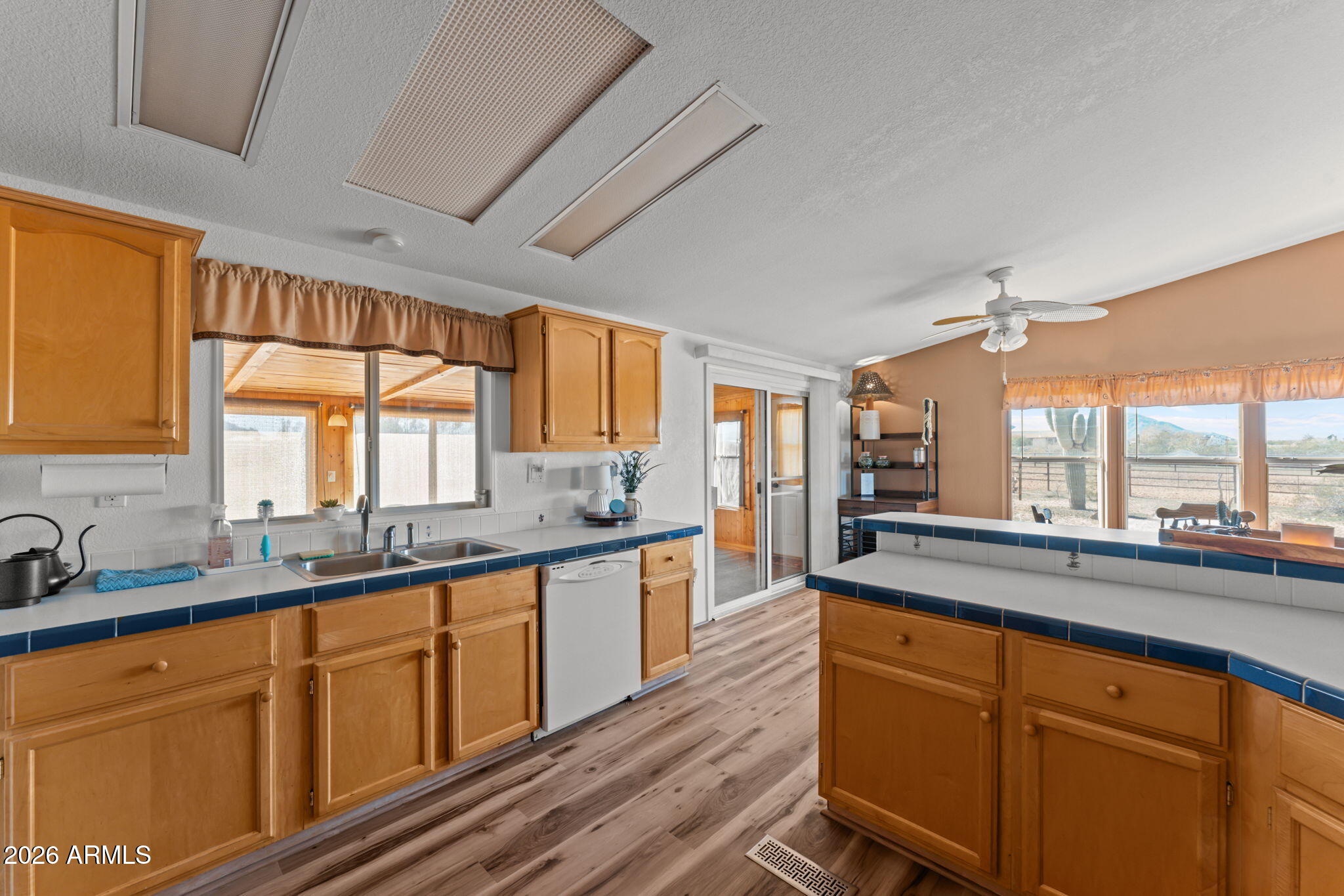 51539 West Donald Road Aguila, AZ 85320 - Photo 27 of 43 a large kitchen with kitchen island granite countertop a large window