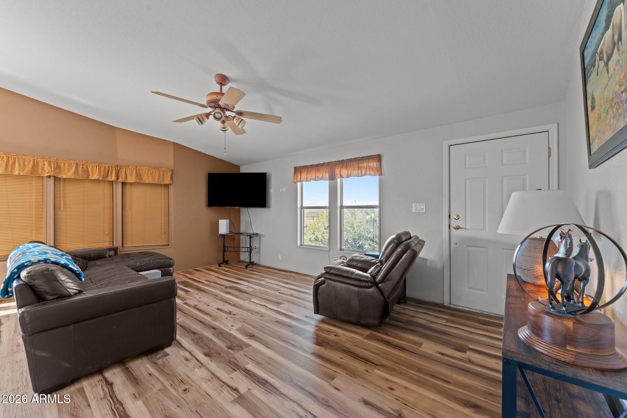 51539 West Donald Road Aguila, AZ 85320 - Photo 31 of 43 a living room with furniture a flat screen tv and a large window